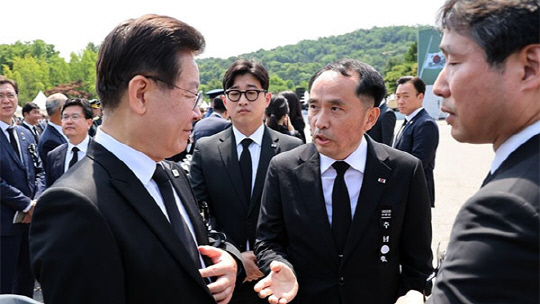 이재명 더불어민주당 대표가 6일 서울 동작구 국립서울현충원에서 열린 제68회 현충일 추념식을 마친 뒤 최원일 전 천안함 함장으로부터 항의를 받고 있다. <연합뉴스>